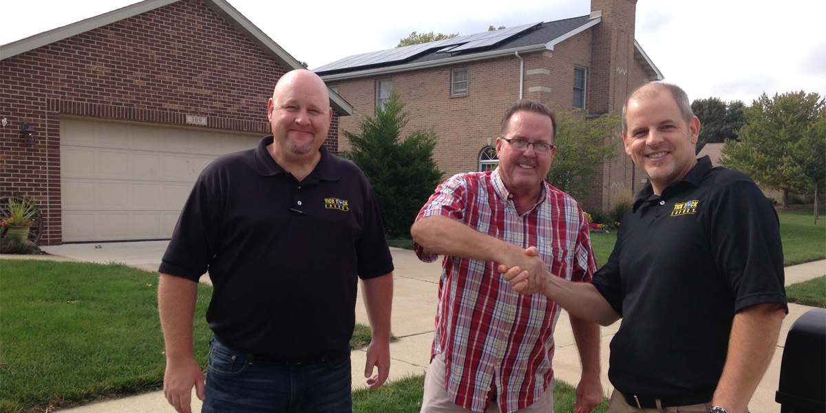 roof mounted solar panels residential homeowner shaking hands