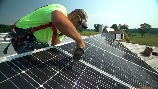 Worker installing solar