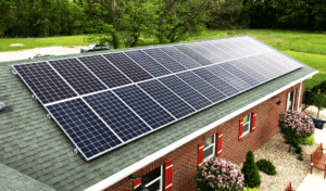 Residential solar panels installed on the roof of a brick home.