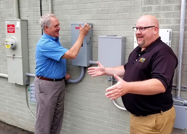 John Shimkus flips solar disconnection switch at Tick Tock Energy