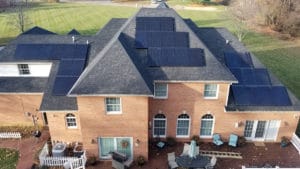 An overhead large single-family home with solar panels on the roof.