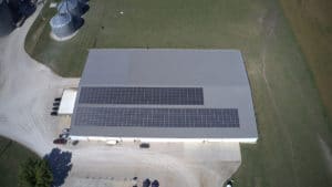 An aerial image of a solar panel system mounted on the roof of an industrial building.
