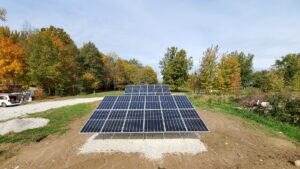 A set of ground-mounted solar panels installed at a single-family home.